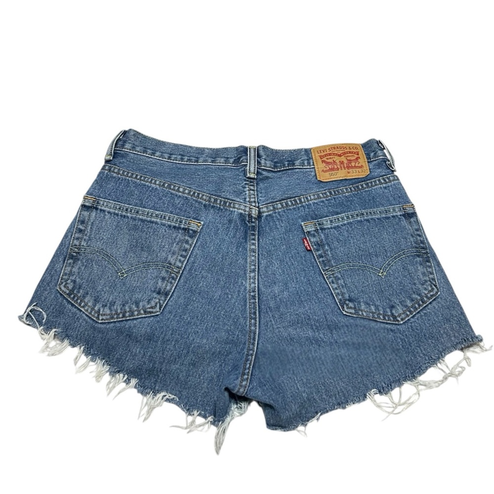 Levi's 550 blue denim shorts with frayed hem. Size 33”